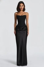 Woman wearing a black strapless gown on a white background