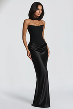 Woman wearing a black strapless gown on a white background