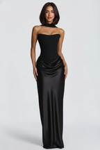 Woman wearing a black strapless gown on a white background