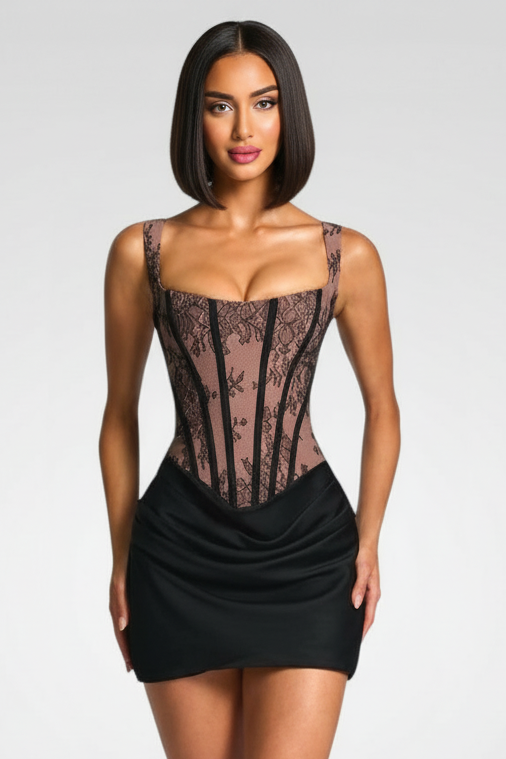 Woman wearing a black lace corset over a black dress on a white background