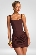 Woman wearing a brown dress on a white background