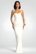 Woman wearing a white evening gown on a plain background