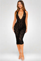 Woman wearing a black lace dress on a white background