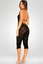 Woman wearing a black lace outfit on a white background