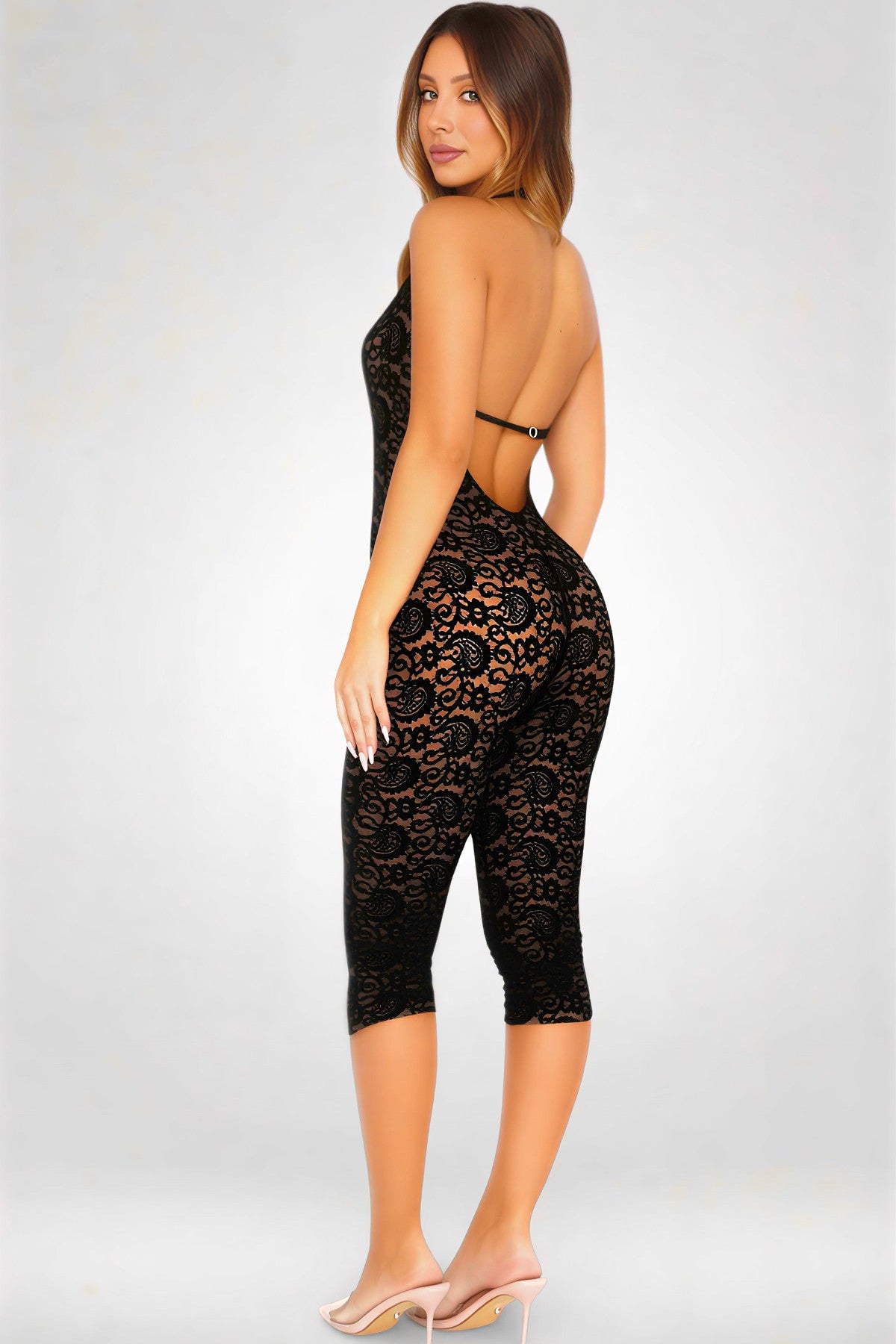 Woman wearing a black lace outfit on a white background