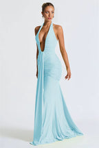 Woman wearing a light blue evening gown with a plunging neckline on a white background