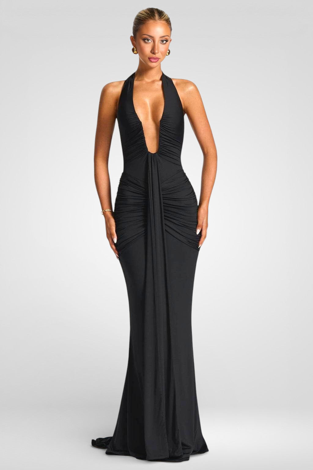 Woman wearing a black evening gown on a gray background