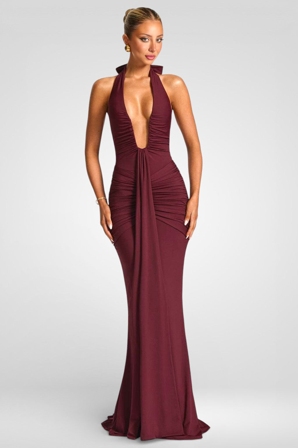Burgundy evening gown with a plunging neckline on a white background