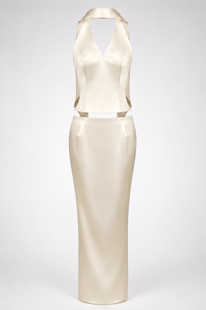 A cream-colored satin dress with a halter neckline and a matching waist belt, displayed on a neutral light gray background.