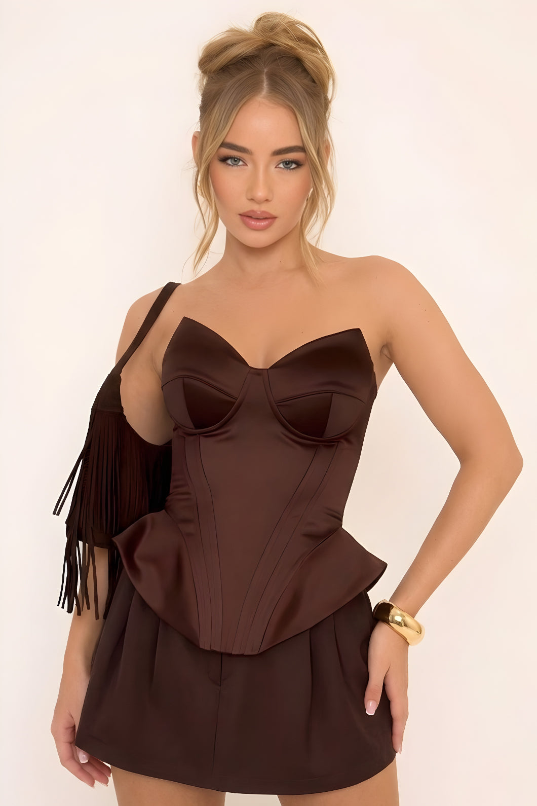 Woman wearing a brown dress with a plain background