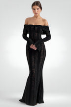 Woman wearing a black off-shoulder evening gown on a white background