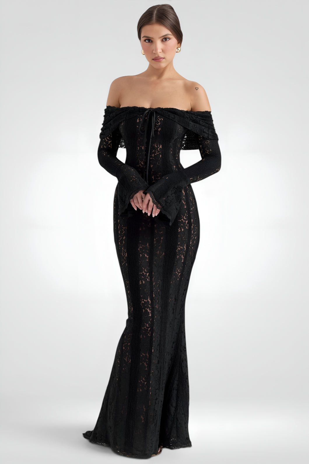 Woman wearing a black off-shoulder evening gown on a white background