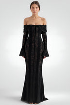 Black off-shoulder dress with floral lace details on a white background