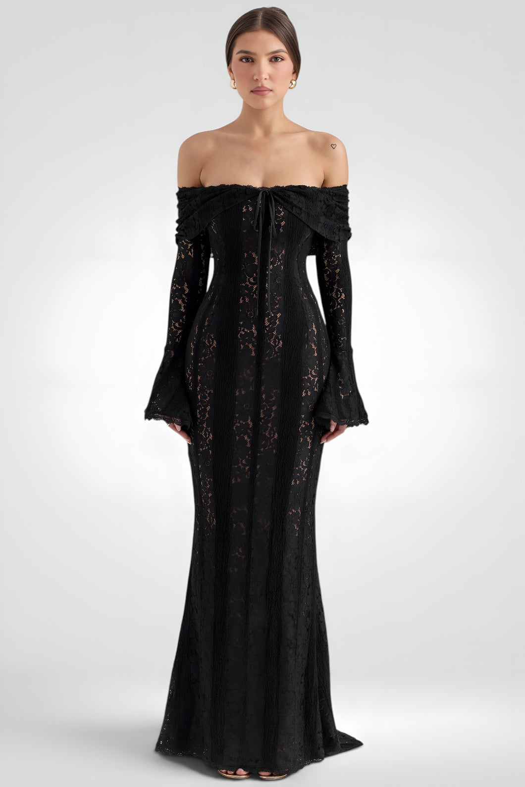 Black off-shoulder dress with floral lace details on a white background