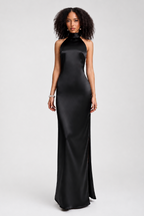 Woman wearing a black halter neck gown on a white background