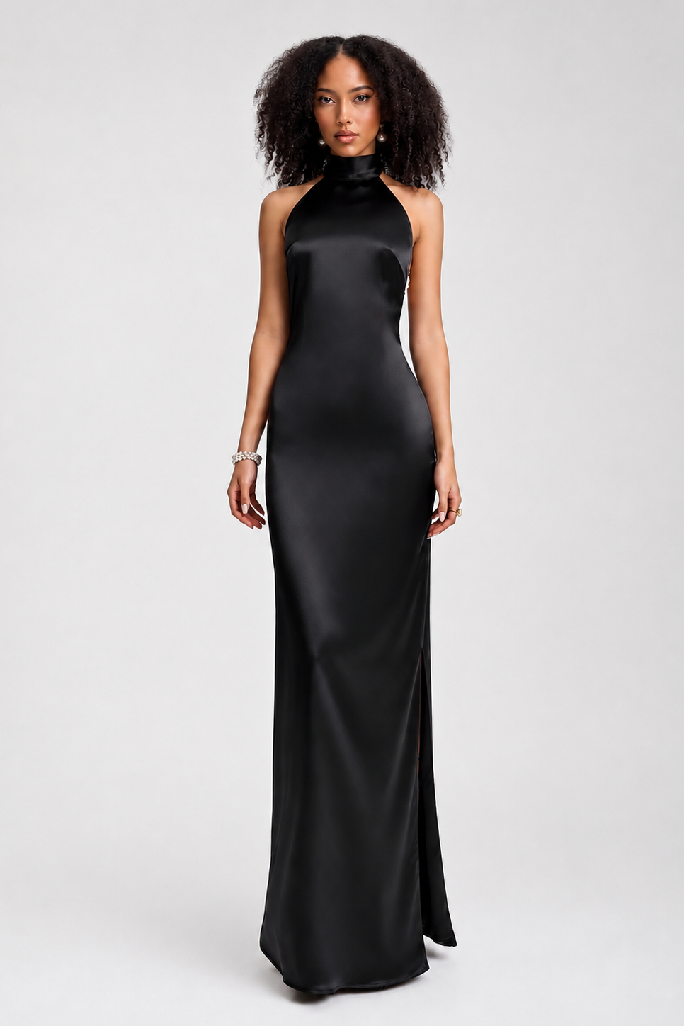 Woman wearing a black halter neck gown on a white background