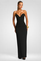 Woman wearing a black strapless gown on a white background