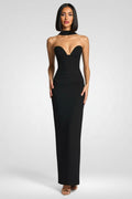 Woman wearing a black strapless gown on a white background