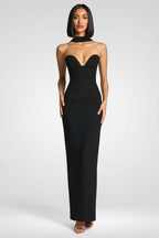 Woman wearing a black strapless gown on a white background
