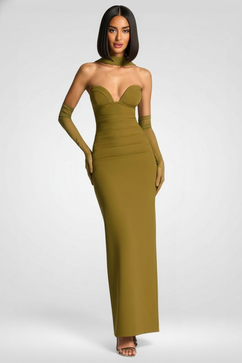 Woman wearing a green strapless gown with matching gloves on a white background