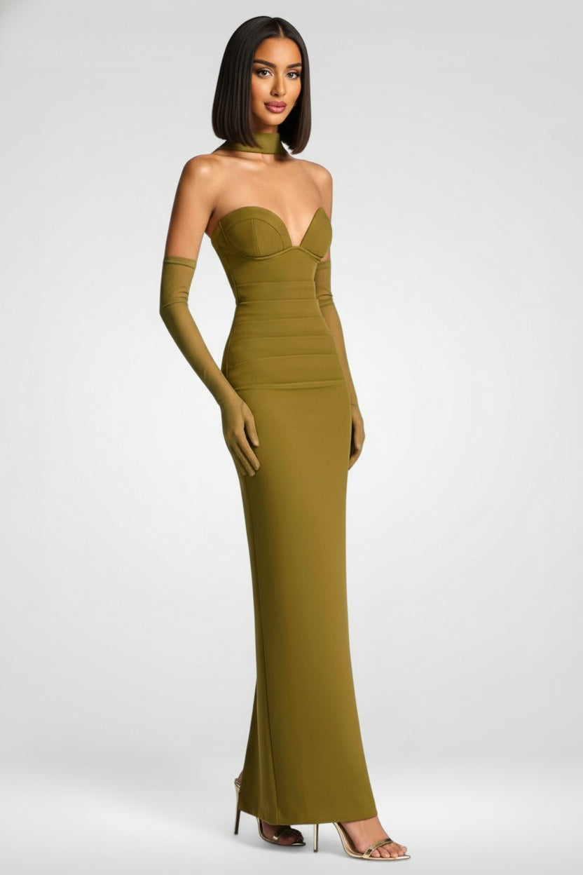 Woman wearing a strapless green evening gown on a white background