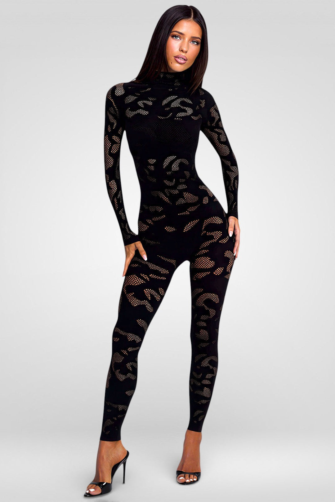 Woman wearing a black leopard print jumpsuit on a white background
