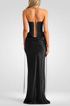 Black strapless gown with open back on a white background