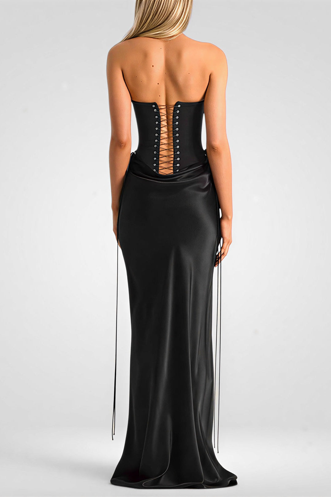 Black strapless gown with open back on a white background