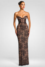 Woman wearing a black lace strapless gown on a white background