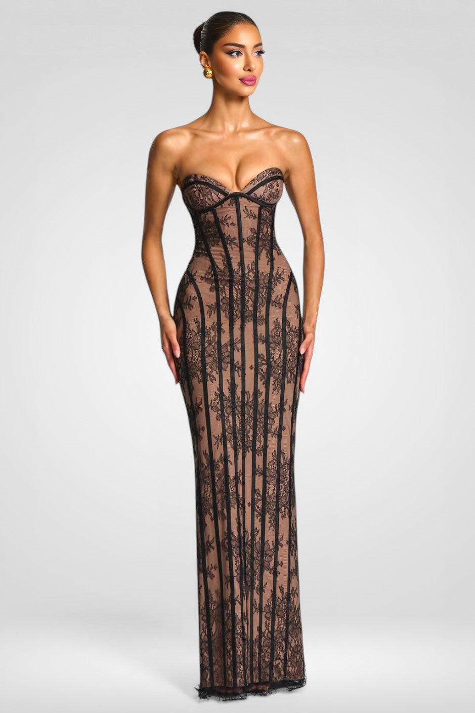 Woman wearing a black lace strapless gown on a white background