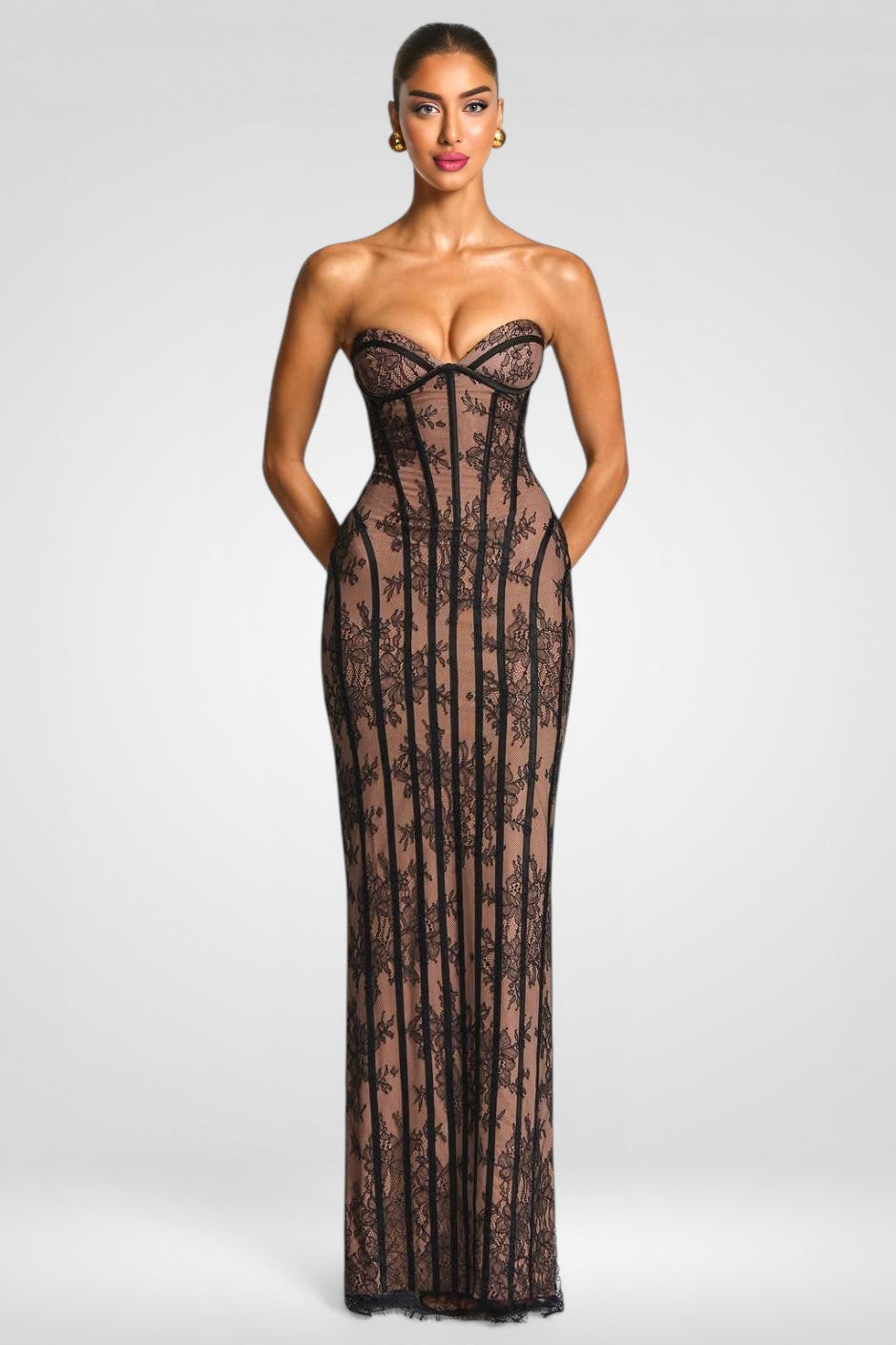 Woman wearing a black lace strapless gown on a white background