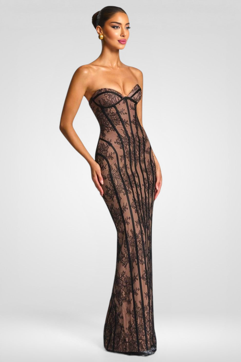 Woman wearing a black lace strapless gown on a white background