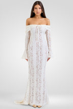 Woman wearing a white lace dress on a plain background