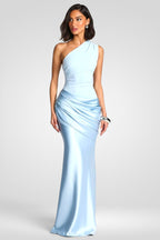 Woman wearing a light blue one-shoulder evening gown on a white background