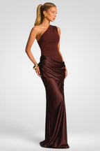 Woman wearing a brown one-shoulder evening gown on a white background