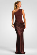 Woman wearing a brown one-shoulder evening gown on a white background