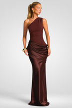 Woman wearing a brown one-shoulder evening gown on a white background