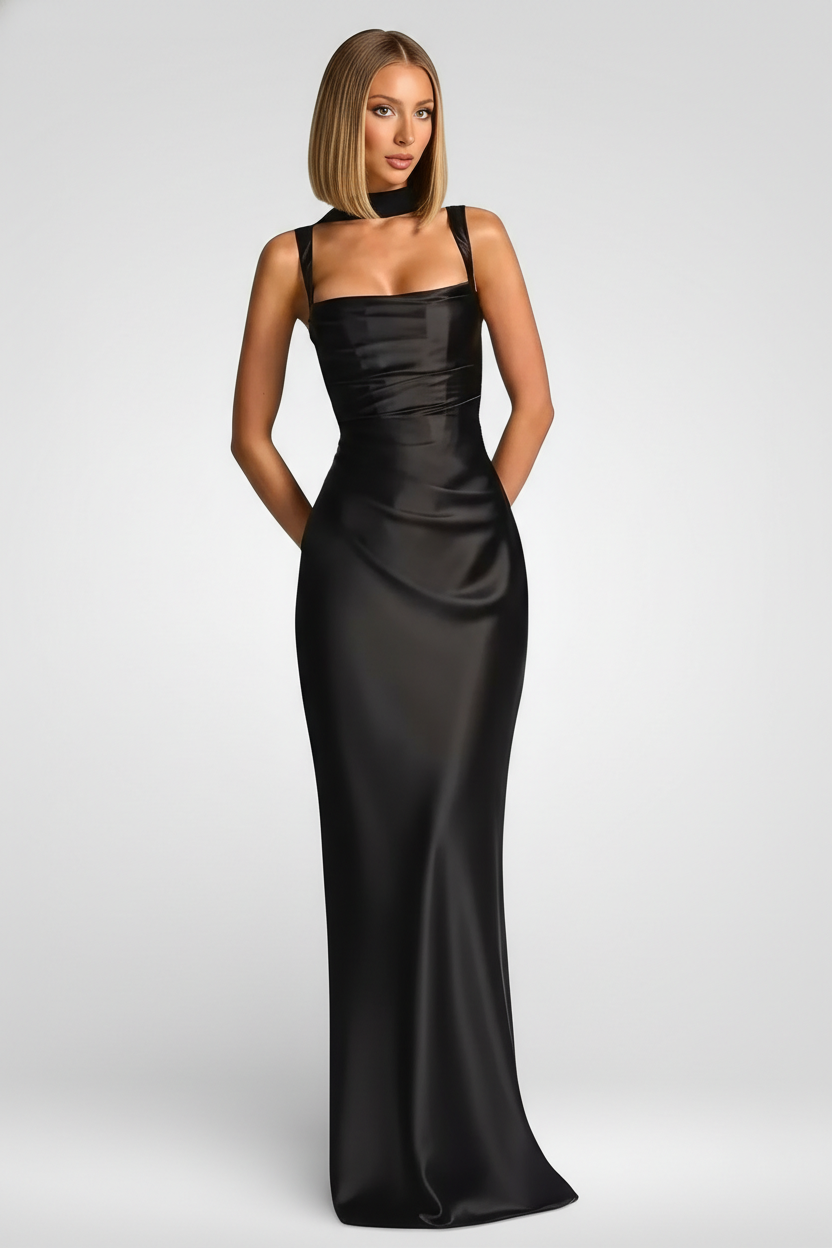Woman wearing a black satin gown on a white background