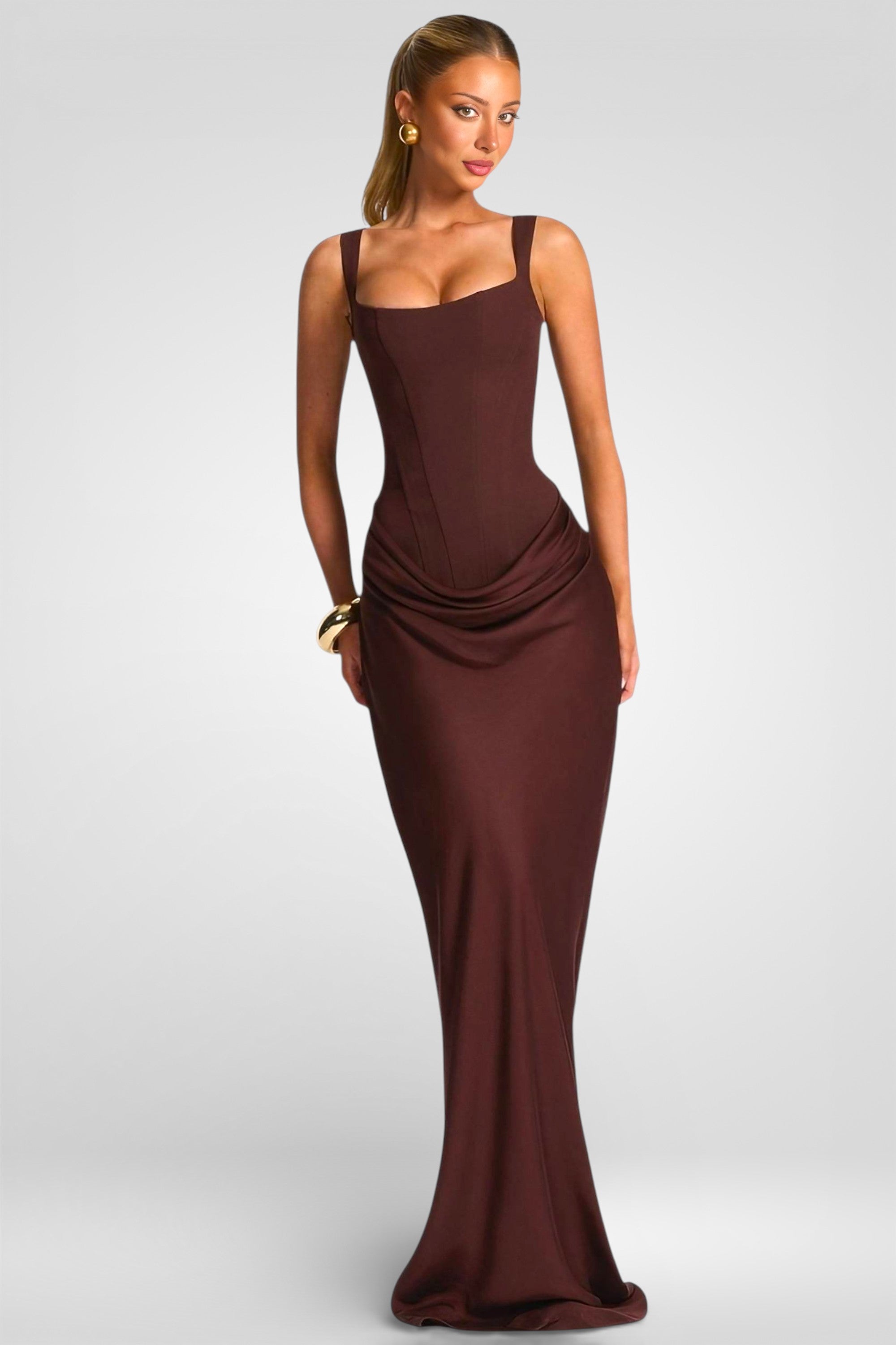 Woman wearing a burgundy evening gown on a white background