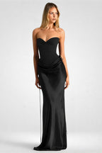 Woman wearing a black strapless gown on a white background