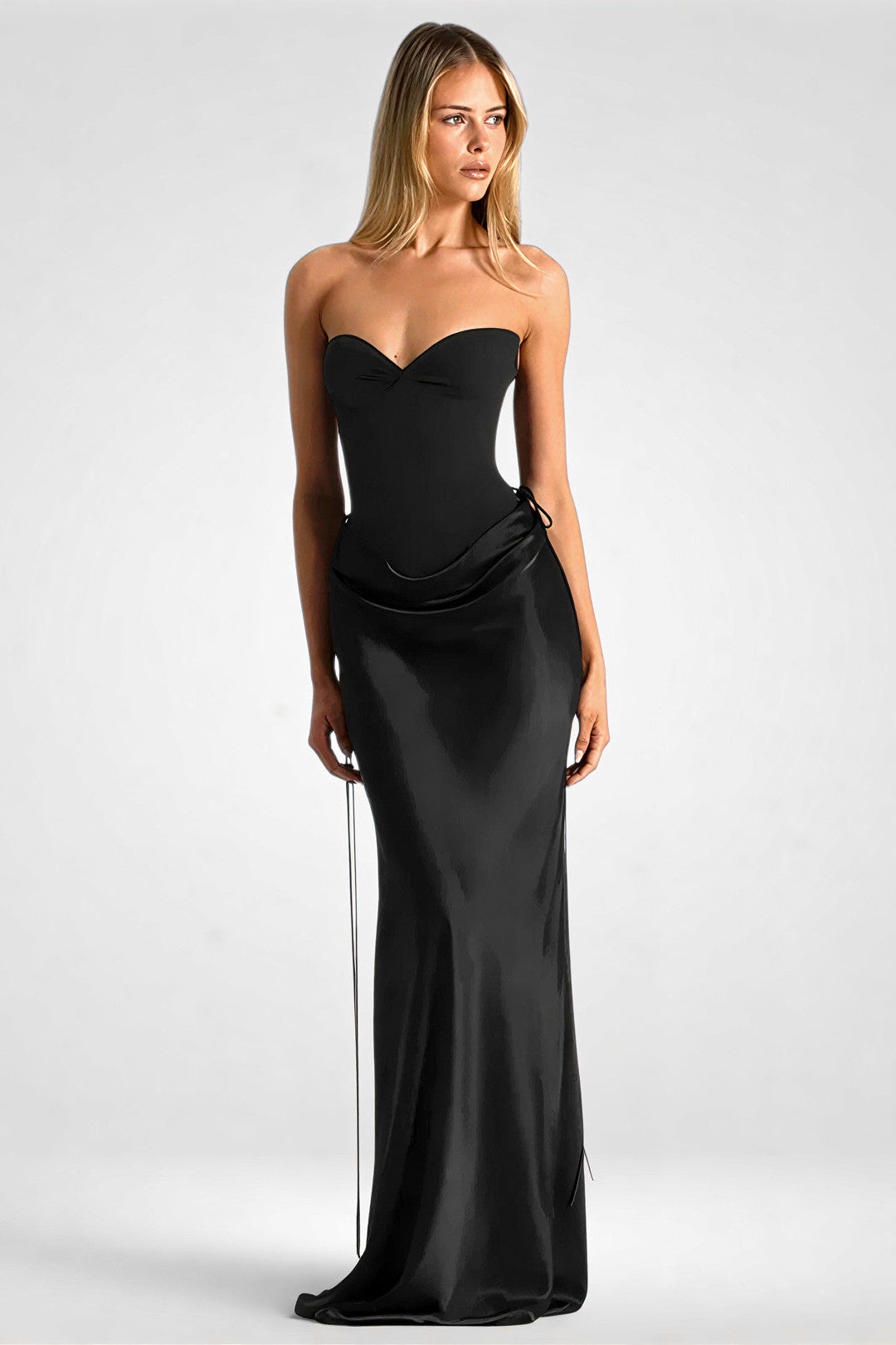 Woman wearing a black strapless gown on a white background