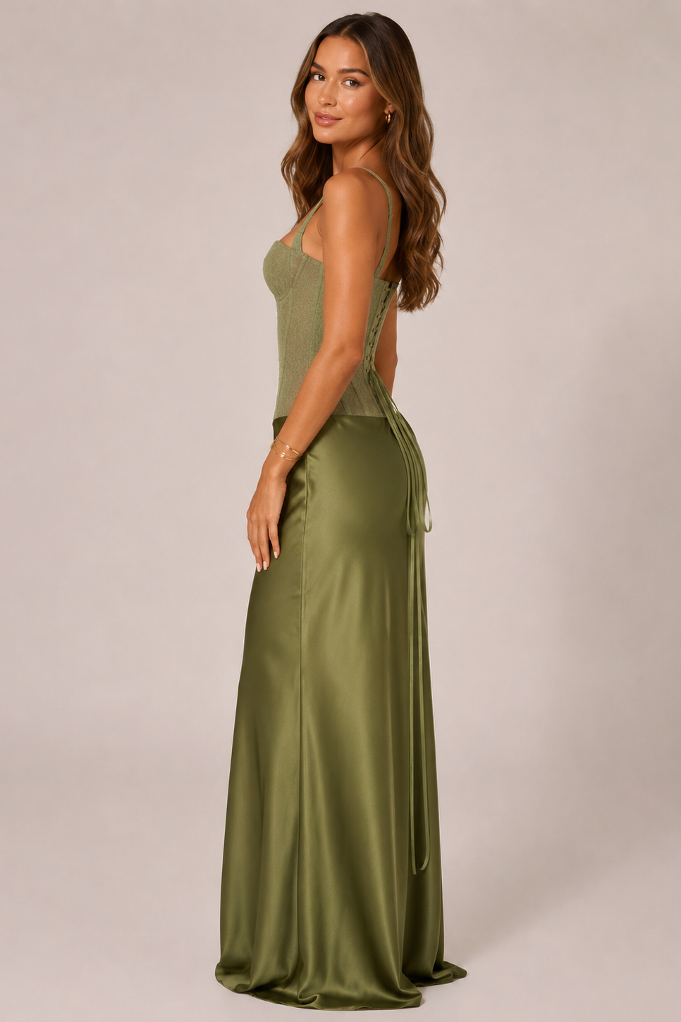 Woman wearing an olive green evening gown with a plain background