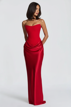 Woman wearing a red strapless gown on a white background