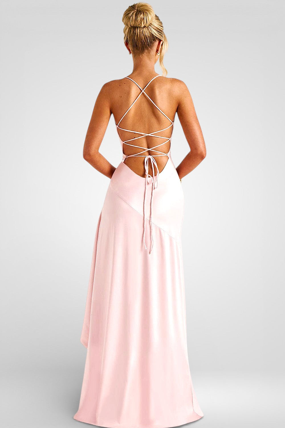 Woman wearing a pink dress with a strappy back design on a gray background
