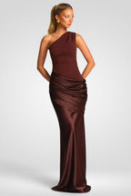 Woman wearing a brown one-shoulder evening gown on a white background